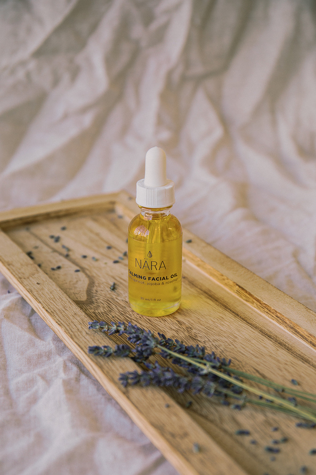 Calming Face Oil Bottle and Fresh Lavender
